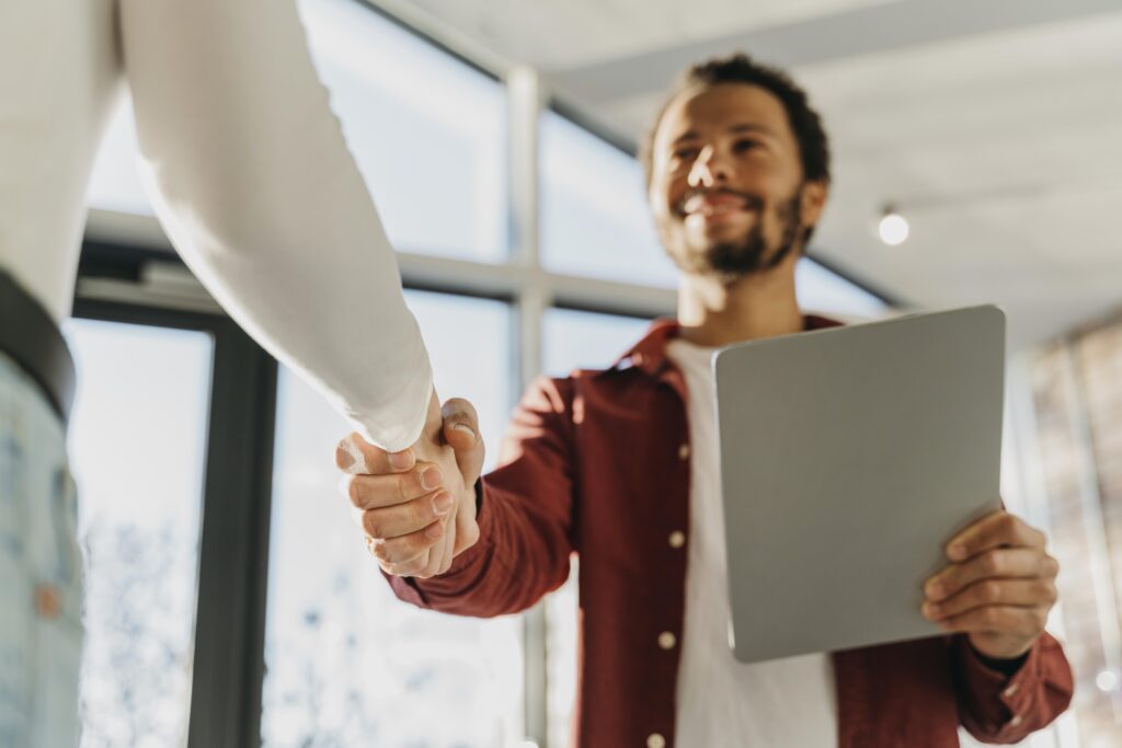 Pessoa jovem e sorridente iniciando um negócio, representando o primeiro passo do empreendedor